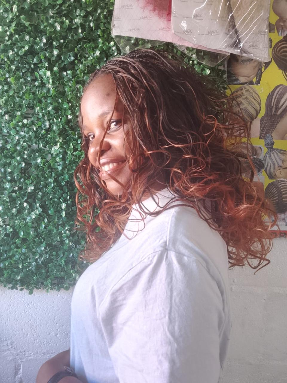 Happy client with micro braids and curly ends