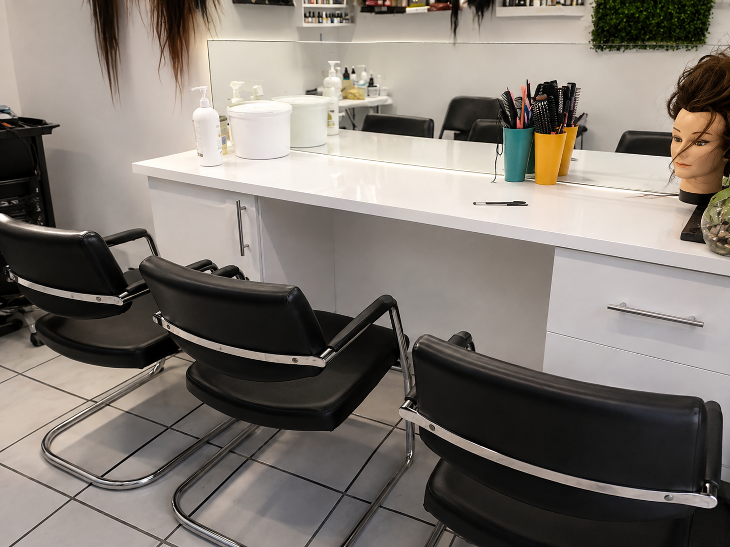 Elegant salon interior with maroon velvet chairs and marble counters
